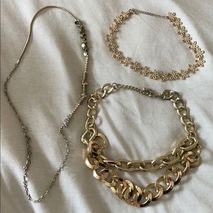Set of three gold costume jewelry necklaces